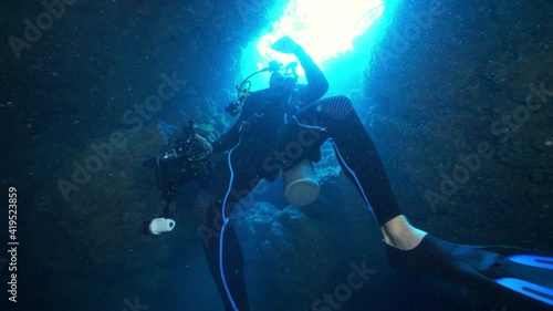 Wallpaper Mural Slow Motion: Man Scuba Diving While Exploring Cave Undersea Torontodigital.ca