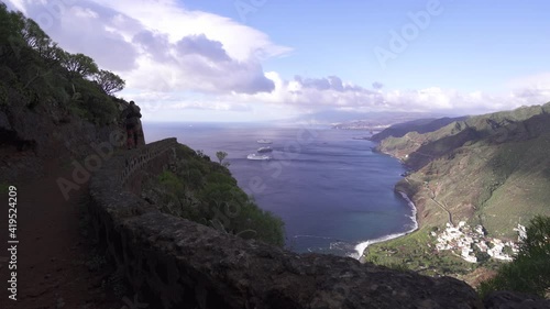 Man Hiking And Watching Beautiful Panorama Of Santa Cruz de Tenerife and Atlantic Ocean photo