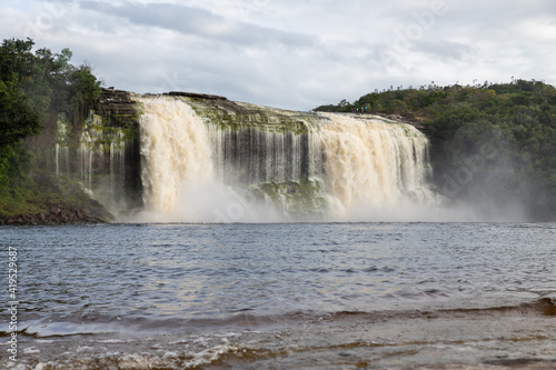View of waterfall Ax falling on the lagoon in Canaima National Park (Venezuela).