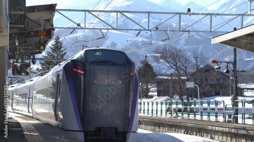 Railroad passing through snowy landscapes and small platforms