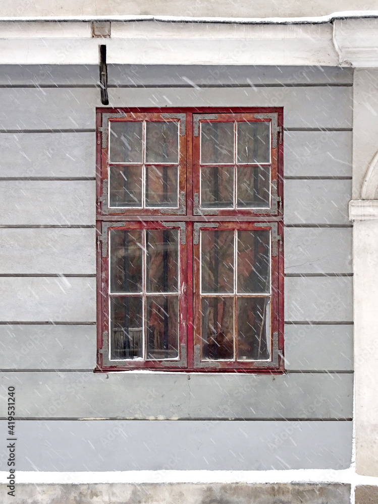 Antique loosely bound window in european city, selective focus