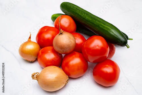 Onion heads  tomatoes and cucumbers close-up  healthy food