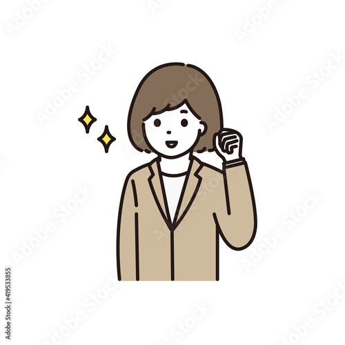 笑顔でガッツポーズをするスーツ姿の若い女性