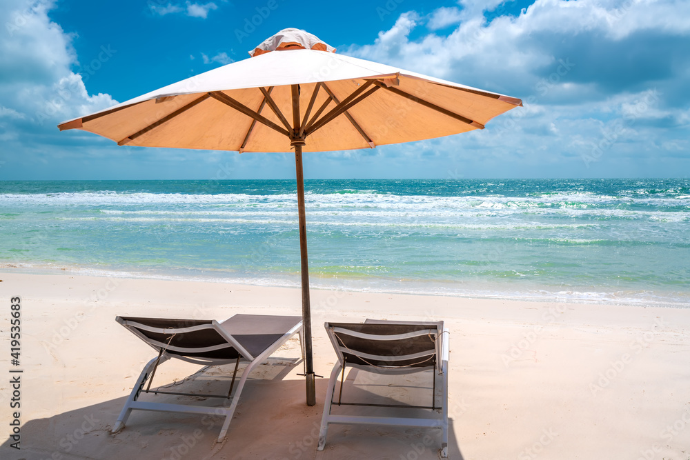 Sunbeds under tropical palms on beach on Phu Quoc island, Vietnam. Beach's smile