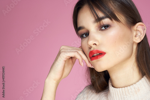 Beautiful brunette red lips white blouse close-up attractive view pink background
