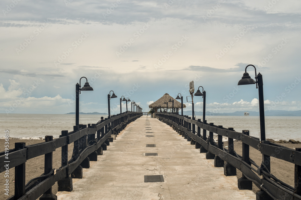 Pier on the beach, with straw Pub,  Puntarenas, Costa Rica