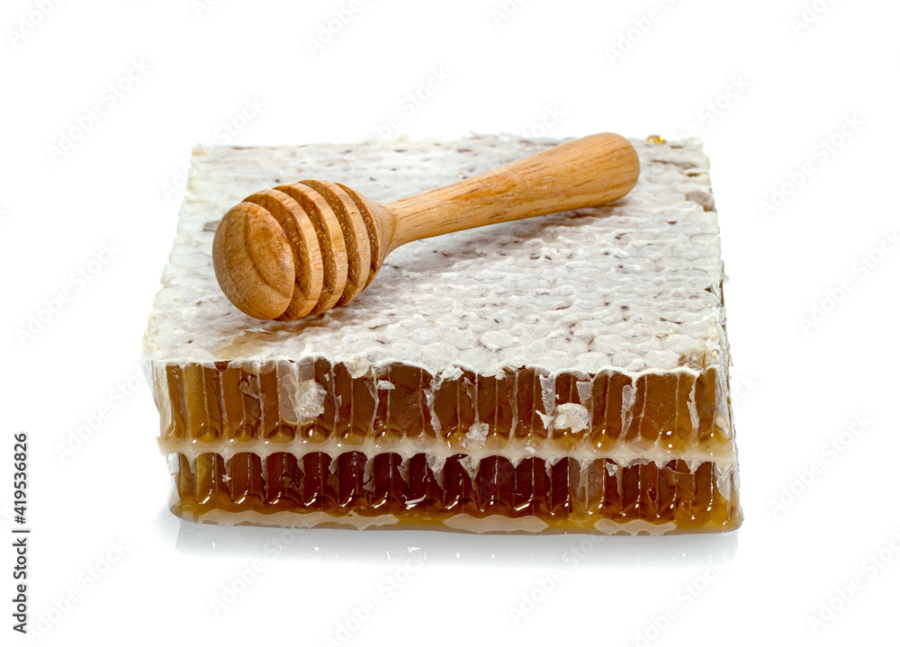 Fresh Honeycomb slice and wooden honey dipper isolated on white background Fresh Honeycomb slice and wooden honey dipper isolated on white background