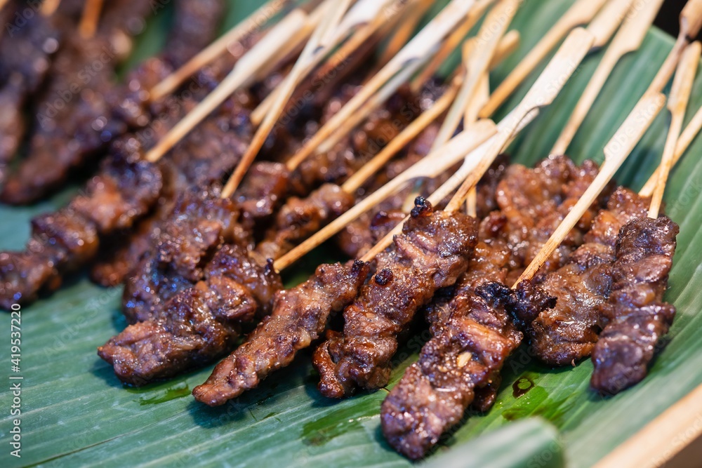 Close up of Grilled Beef Skewers with wood stick, thai street food market