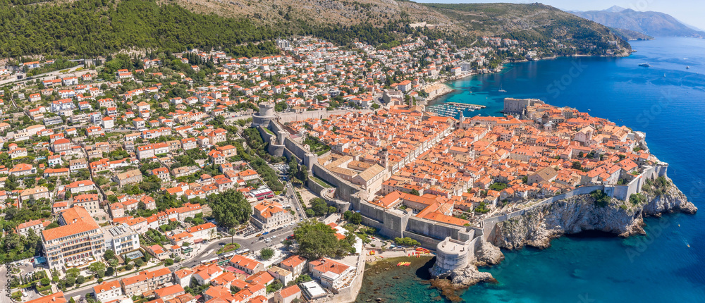 Aerial panorama drone shot of old town Dubrovnik by Adriatic sea in Croatia summer noon