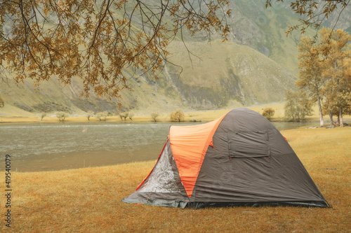 hiking tent on the beach of river. side view