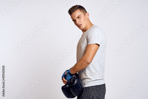Sportive man boxing bandages on workout hands in gym exercises © SHOTPRIME STUDIO