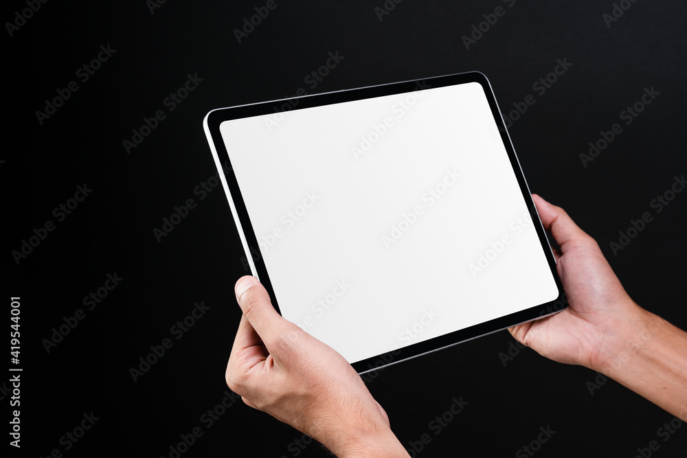 Hand holding digital tablet with blank white screen Hand holding digital tablet with blank white screen