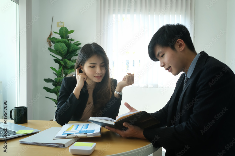 Two business colleagues discussing about new project in modern office. Two business colleagues discussing about new project in modern office.