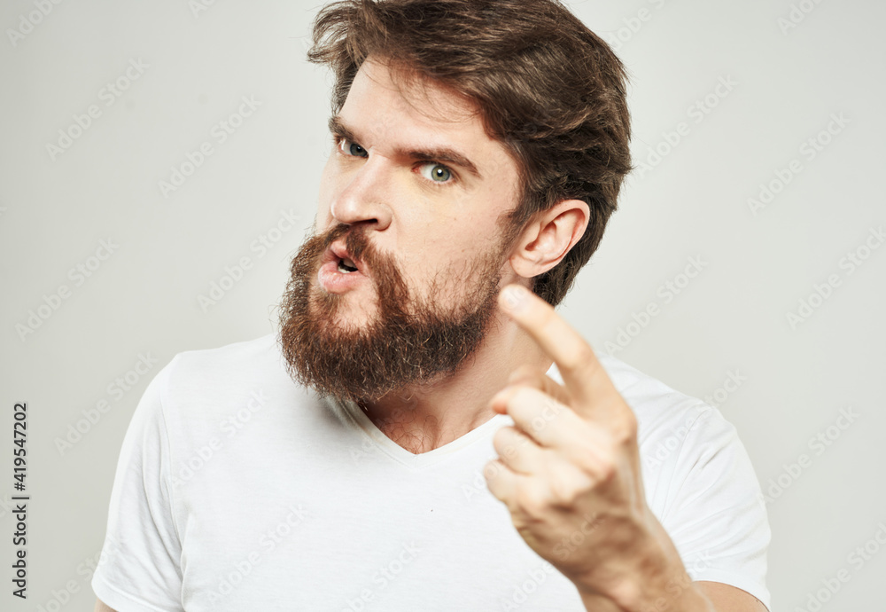 The guy in the T-shirt shows the index finger and emotions model an indignant look The guy in the T-shirt shows the index finger and emotions model an indignant look