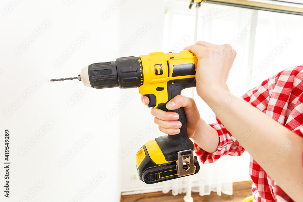 Hand holding yellow drill