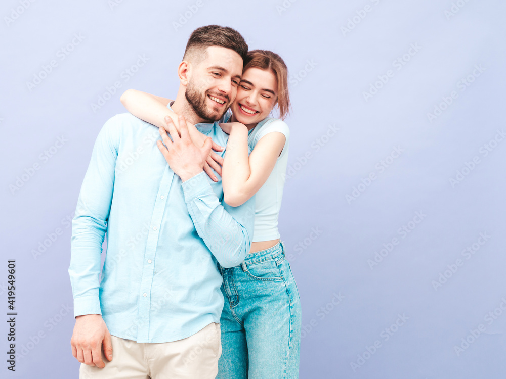 Smiling beautiful woman and her handsome boyfriend. Happy cheerful family having tender moments near purple wall in studio.Pure cheerful models hugging.Embracing each other Smiling beautiful woman and her handsome boyfriend. Happy cheerful family having tender moments near purple wall in studio.Pure cheerful models hugging.Embracing each other