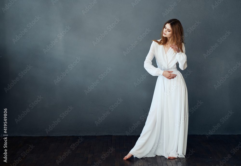 Woman in white dress on gray background red hair model romance Copy Space Woman in white dress on gray background red hair model romance Copy Space