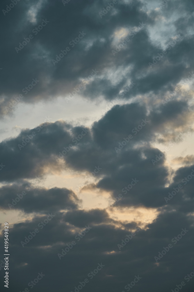 view of the dramatic sunset sky with heavy dark cumulus clouds. picturesque artistic backdrop for atmospheric design. dramatic evening cloudscape. telephoto of cumulus clouds