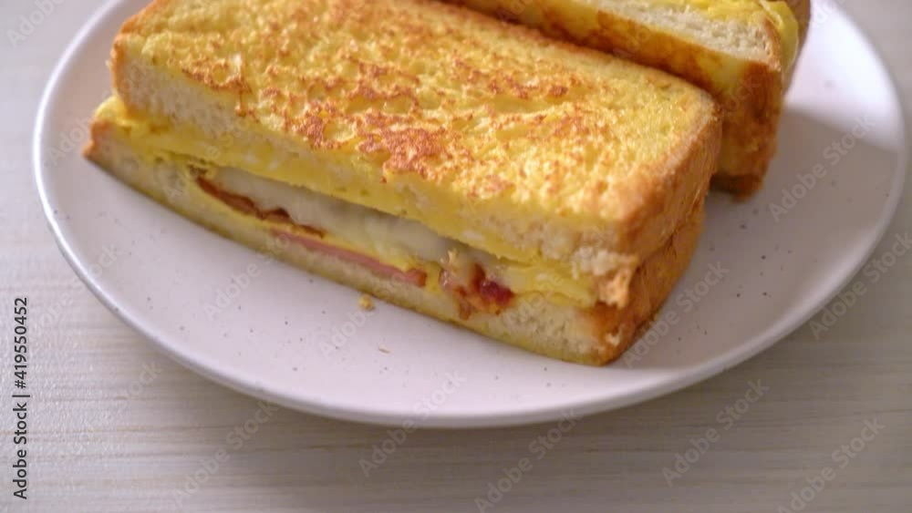 Homemade French toast ham bacon cheese sandwich with egg Homemade French toast ham bacon cheese sandwich with egg