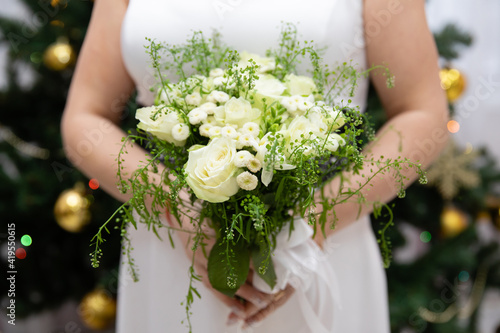 Beautiful wedding bouquet of flowers in the hands of the bride