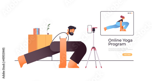 young man doing stretching exercises while watching online video training program with female yoga teacher workout concept full length horizontal copy space vector illustration