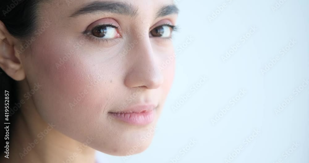 Close up face of beautiful woman over white background Close up face of beautiful woman over white background