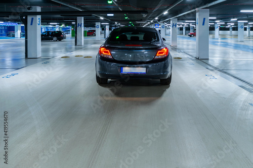 Parking lot. Car lot parking space in underground city garage. Empty road asphalt background. Ground floor for car parking. © Maksym
