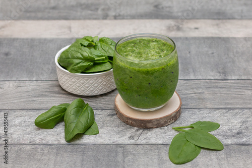 Healthy dieting and nutrition, food and drink, vegan, vegetarian concept, healthy lifestyle. Green smoothie with organic ingredients, vegetables on a wooden table 