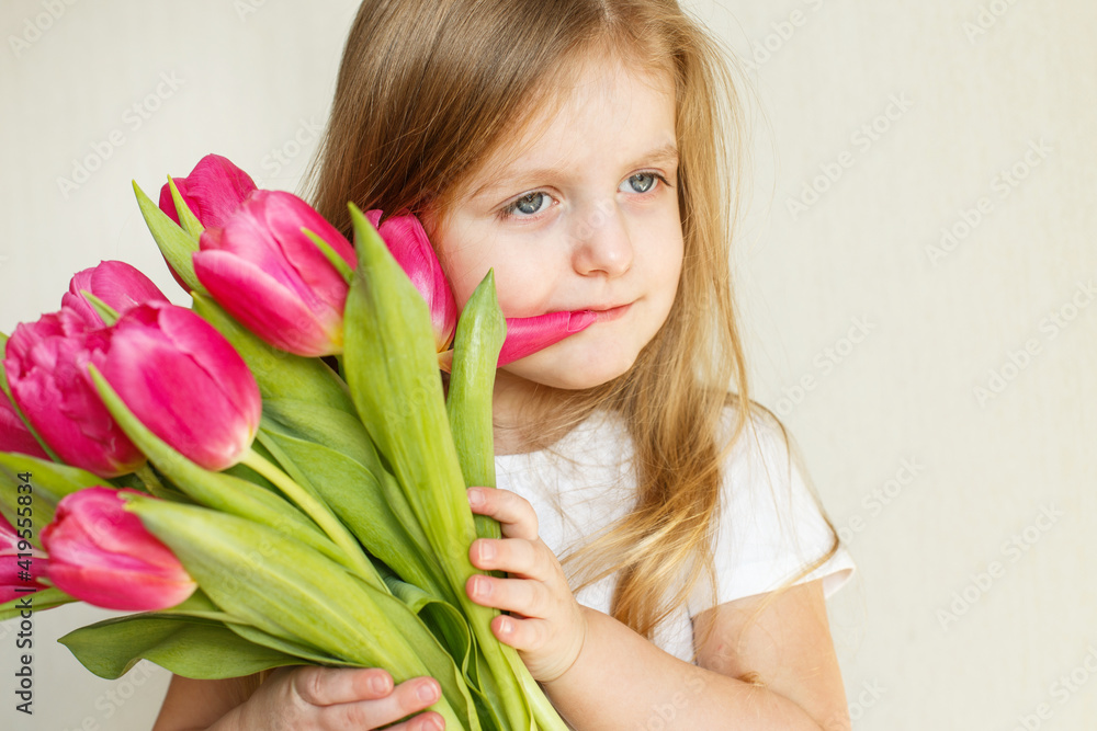 portrait of litlle girl with bouquet of flowers tulips in her hands portrait of litlle girl with bouquet of flowers tulips in her hands