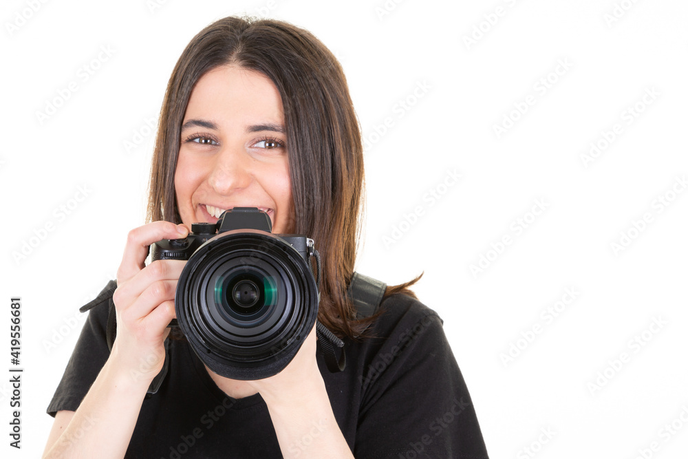 Young brunette woman with a professional camera over isolated white background Young brunette woman with a professional camera over isolated white background