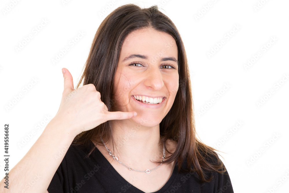 Young beautiful woman over isolated white background smiling doing phone gesture with hand and fingers like talking on the telephone Young beautiful woman over isolated white background smiling doing phone gesture with hand and fingers like talking on the telephone