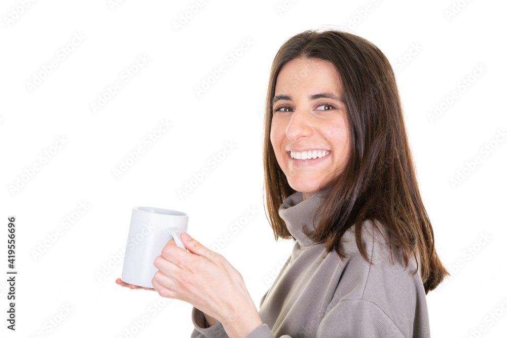Young woman over isolated white background holding hot cup of coffee in blank mug Young woman over isolated white background holding hot cup of coffee in blank mug