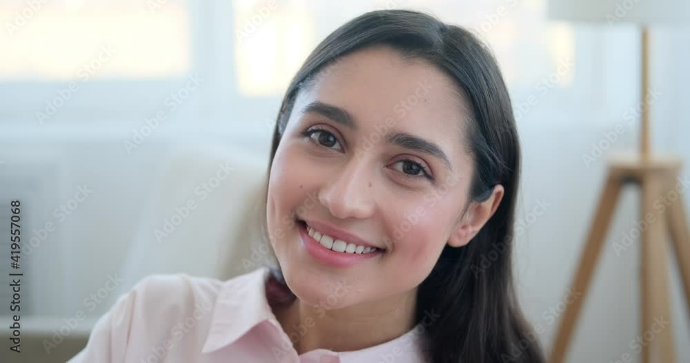 Confident young woman smiling at home Confident young woman smiling at home