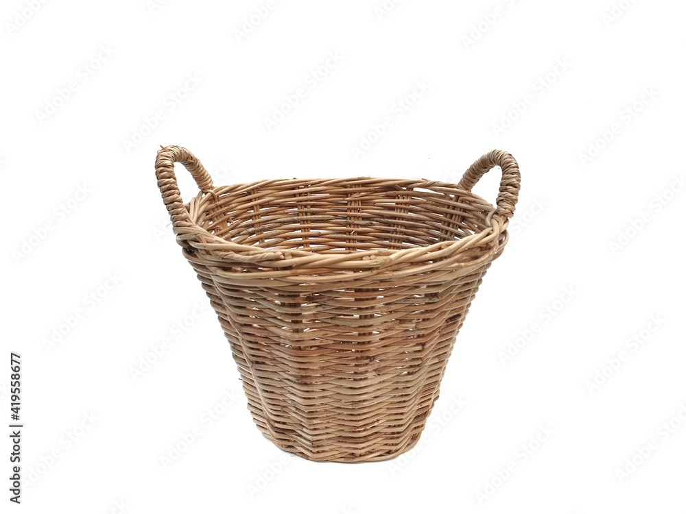 Basket with handles made of rattan. wicker basket isolated on white background with copy space.