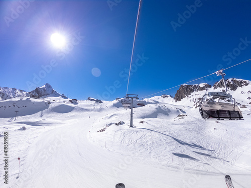 winter skiing area with cable car in sunny day