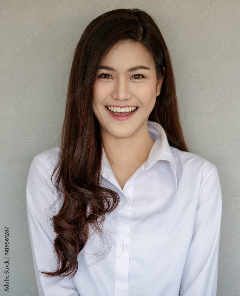 Cute happy cheerful young woman with straight black long hair, looking at camera with a joyful and charming smile showing her white teeth while feeling happy and carefree positive thinking Cute happy cheerful young woman with straight black long hair, looking at camera with a joyful and charming smile showing her white teeth while feeling happy and carefree positive thinking