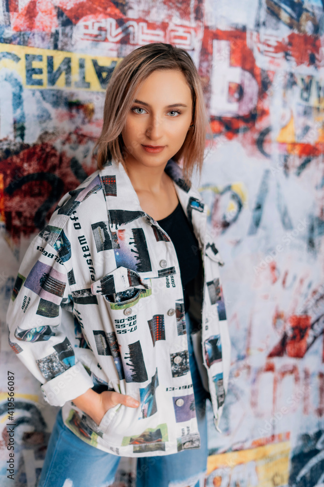 fashionable woman with graffitti style background coloured blazer jacket business crazy style blue jeans black top sexy fashionable woman with graffitti style background coloured blazer jacket business crazy style blue jeans black top sexy