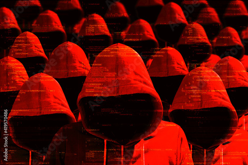 Group of hooded hackers in red cybersecurity concept photo
