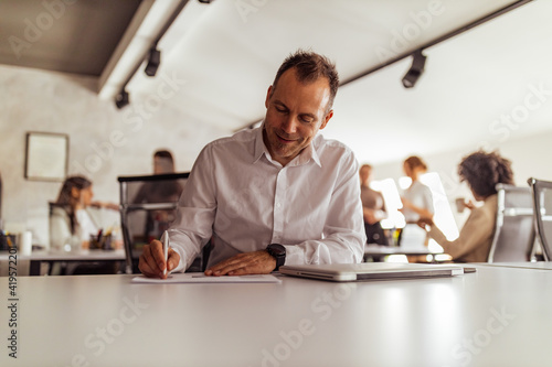 Doing daily work, wearing white shirt.