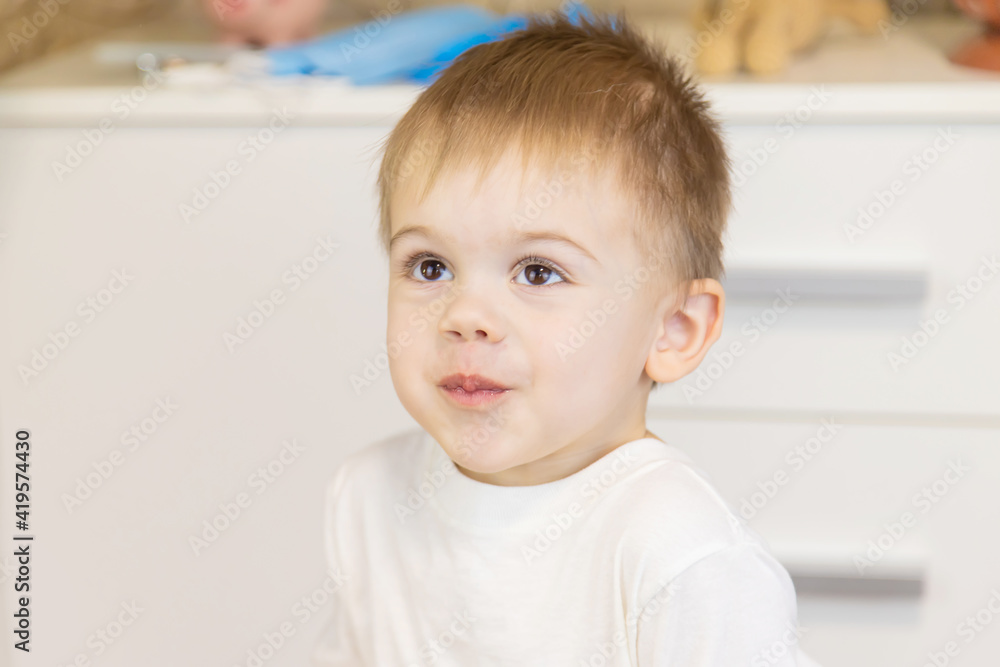 The child drinks water from a glass. Selective focus. The child drinks water from a glass. Selective focus.