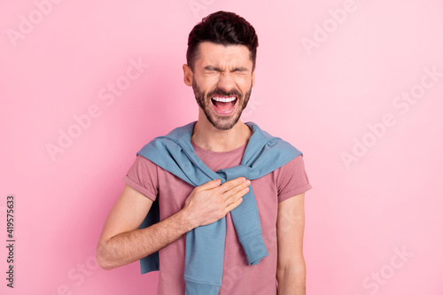 Photo of happy cheerful positive young man laugh comic good joke isolated on pastel pink color background © deagreez