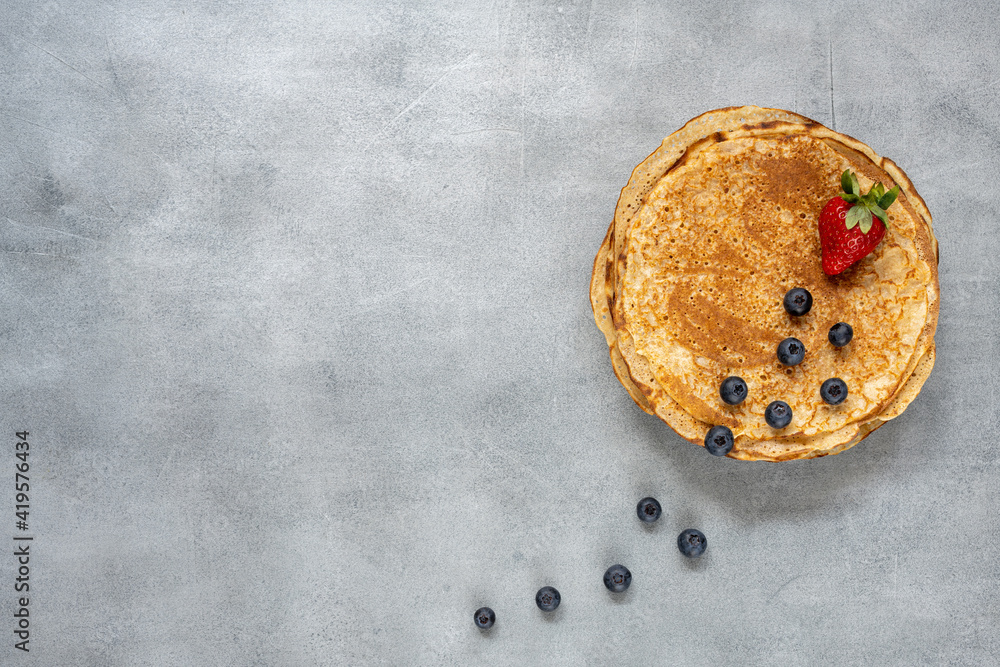 Tasty homemade rustic pancake on concrete background. Table top view. Maslenitsa food Tasty homemade rustic pancake on concrete background. Table top view. Maslenitsa food