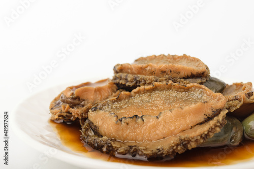 Pickled abalone in soy sauce on a white background