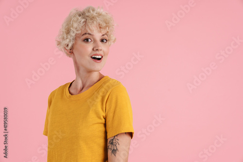 Young casual smiling woman standing isolated