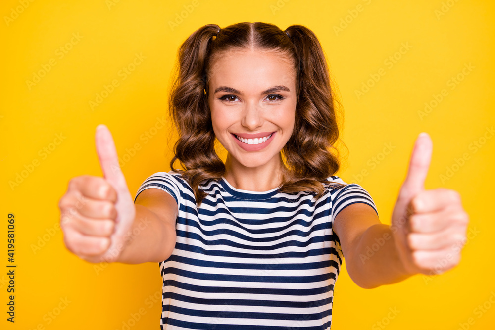 Portrait of attractive cheerful girl giving you two double thumbup ad nice isolated on bright yellow color background Portrait of attractive cheerful girl giving you two double thumbup ad nice isolated on bright yellow color background