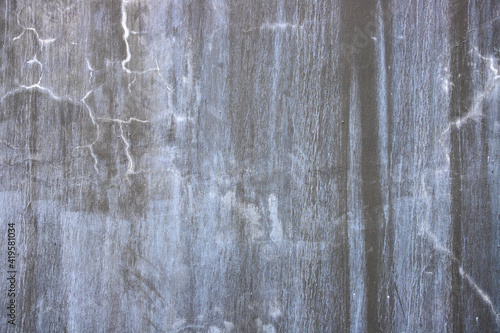 Concrete wall with dirt and crack. Faded grey asphalt closeup. Cracked concrete surface top view. Old building wall abstraction. Natural material background for shabby design. Concrete wall texture