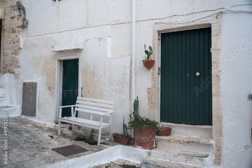 facade with doors and bench in Ostunis oldtown, Puglia © schame87