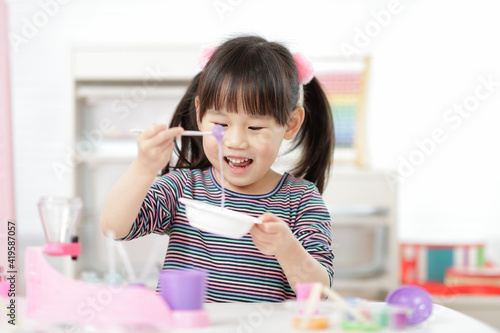 young girl making slime at home