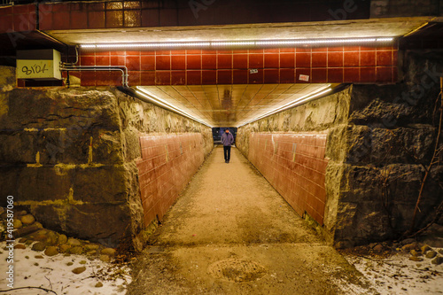Photography Stockholm, Sweden  A person walking in an underground passage in the Tungelsta suburb