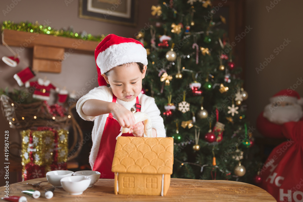 young girl making gingerbread house at home young girl making gingerbread house at home